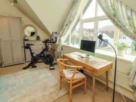 A home office with a desk and bike at Lakes View in Keswick
