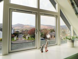A window view of mountains and houses at Lakes View in Keswick