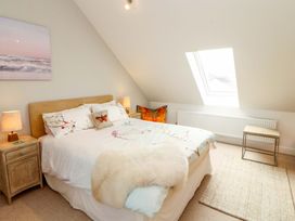 A bedroom with a bed and side table at Lakes View in Keswick
