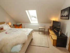 A bedroom with a bed and television at Lakes View in Keswick