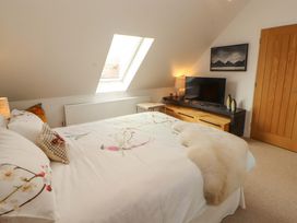 A bedroom with a bed and television at Lakes View in Keswick