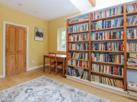 A study with a bookshelf and table at Inglewood Bach in Conwy