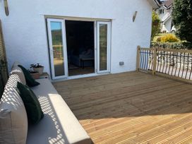 An outdoor area with a sofa and potted plant at Inglewood Bach in Conwy