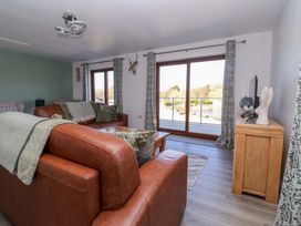 A living room with a sofa and coffee table at Star Carr Lakes