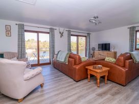A living room with sofas and a TV at Star Carr Lakes