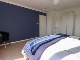 A bedroom with a bed and wardrobe at Star Carr Lakes