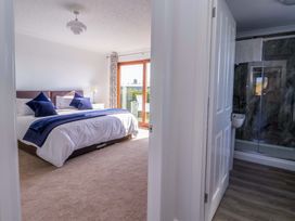 A bedroom with a bed and attached bathroom at Star Carr Lakes