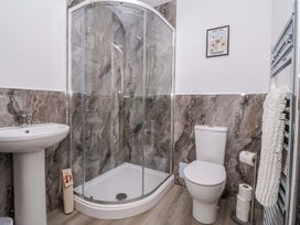 A bathroom with a shower, sink, and toilet at Star Carr Lakes