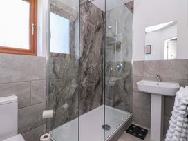 A bathroom with a shower, toilet and sink at Star Carr Lakes 