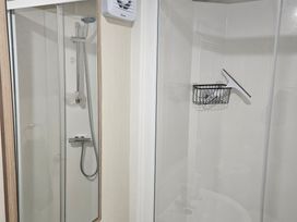 A shower area with controls and storage at Homeslea 33 Millennium Gardens in Morpeth