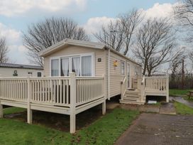 A mobile home with a deck and steps at Homeslea 33 Millennium Gardens Morpeth