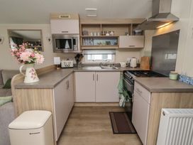 A kitchen with a sink and stove at Homeslea 33 Millennium Gardens in Morpeth