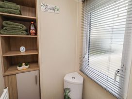 A bathroom with towels and a toilet at Homeslea 33 Millennium Gardens in Morpeth
