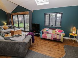 A living room with a sofa and a coffee table at Otter's Rest in Droitwich