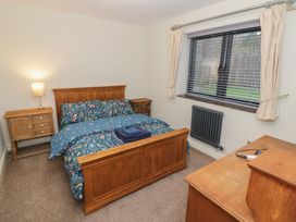 A bedroom with a bed and bedside table at Otter's Rest in Droitwich