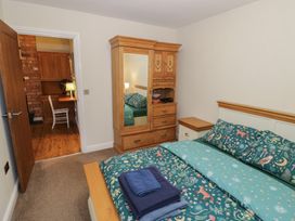 A bedroom with a bed and wardrobe at Otter's Rest in Droitwich