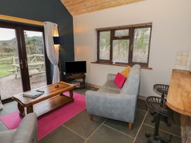 A living room with a sofa and coffee table at The Barn on The Lagoon Droitwich