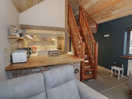 A kitchen with a countertop and staircase at The Barn on The Lagoon Droitwich