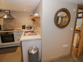 A kitchen with appliances and a mirror at The Barn on The Lagoon Droitwich