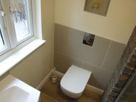 A bathroom with a sink and toilet at Woodland Lodge The Snug Filby