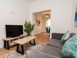 A living room with a television and coffee table at Holmwood