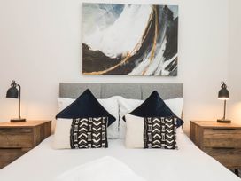 A bedroom with a bed and bedside tables at Holmwood