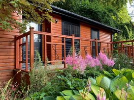A cabin with steps and railing surrounded by plants at The Hermitage Penrith