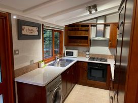 A kitchen with a sink, microwave, and oven at The Hermitage in Penrith