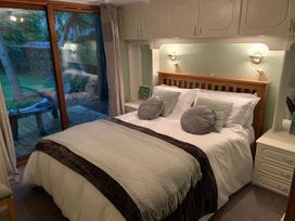 A bedroom with a bed and outdoor view at The Hermitage in Penrith