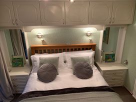 A bedroom with a bed and nightstands at The Hermitage in Penrith