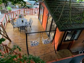 A deck with a table and chairs at The Hermitage in Penrith