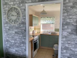 A kitchen with cabinets and a sink at Chalet 58 California, Norfolk