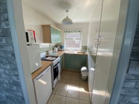 A kitchen with appliances and cabinets at Chalet 58, California, Norfolk