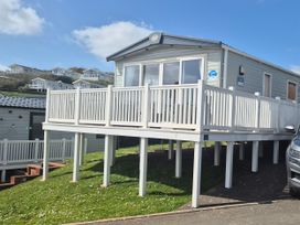 A mobile home with a deck and steps at 21 Gorse Hill in Exmouth