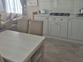 A kitchen with a dining table and chairs at 21 Gorse Hill Exmouth