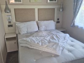 A bedroom with a bed and bedside table at 21 Gorse Hill in Exmouth