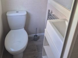 A bathroom with a toilet and sink at 21 Gorse Hill, Exmouth
