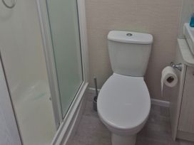 A bathroom with a toilet and shower at 21 Gorse Hill Exmouth