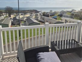 A view of caravans and the sea from a deck at 21 Gorse Hill in Exmouth