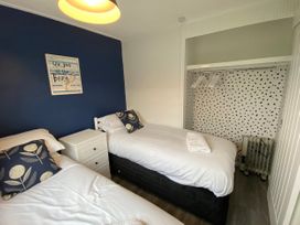 A bedroom with two beds and a wardrobe at Chalet 333, California, Norfolk