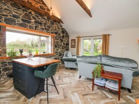 A living room with a table and chairs and a sofa at The Stable in Dublin