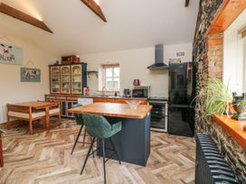 A kitchen with wooden cabinets and appliances at The Stable in Dublin