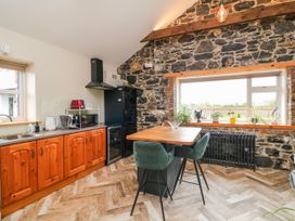 A kitchen with wooden cabinets and dining area at The Stable in Dublin