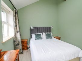A bedroom with a bed and bedside tables at The Stable in Dublin