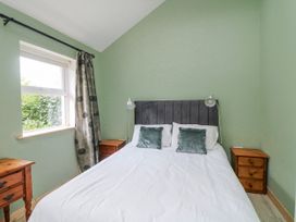 A bedroom with a bed and bedside tables at The Stable in Dublin