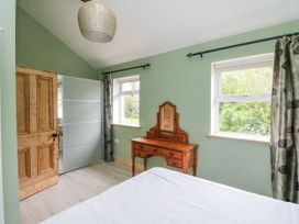 A bedroom with a dressing table and a window at The Stable in Dublin