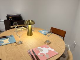 A dining room with a round table set for dinner at Amber Rose in Berwick-upon-Tweed