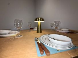 A dining table set with plates and glasses at Amber Rose in Berwick-upon-Tweed