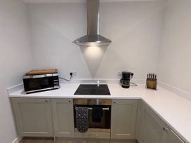 A kitchen with a microwave and an induction cooktop at Amber Rose in Berwick-upon-Tweed
