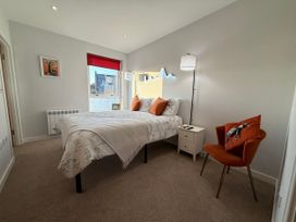 A bedroom with a bed and a chair at Amber Rose in Berwick-upon-Tweed